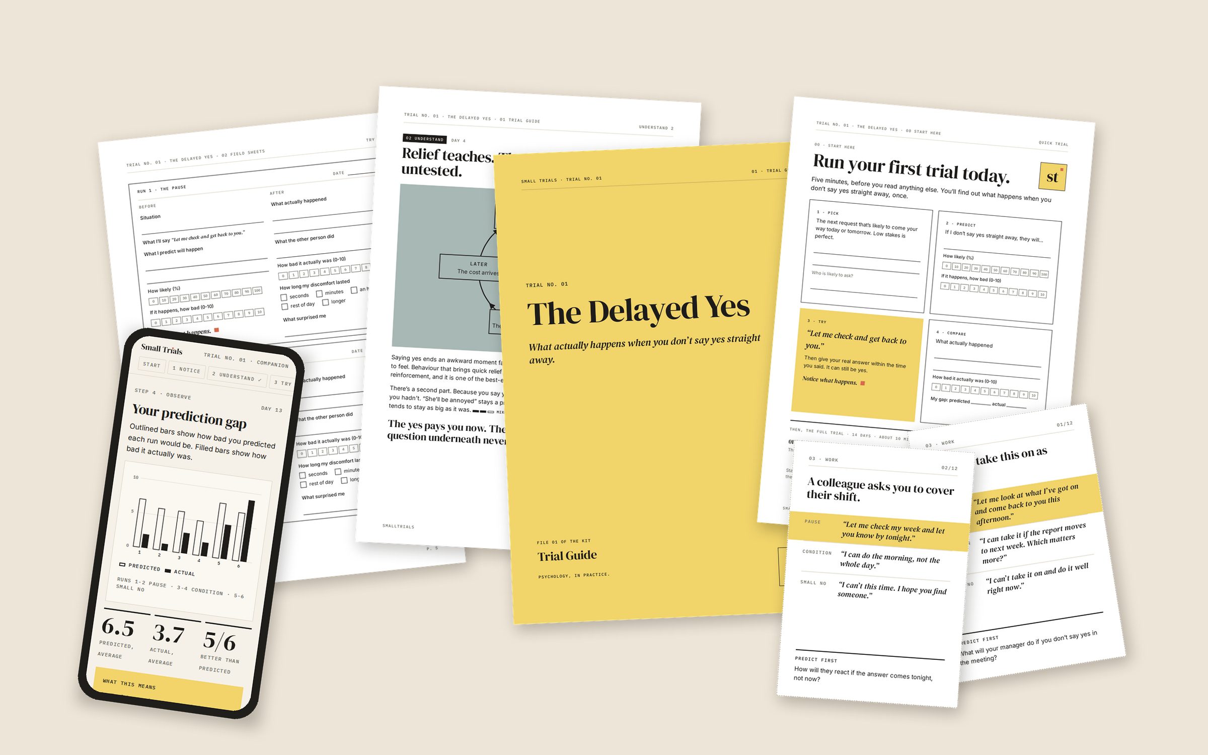 The contents of Trial No. 01 laid out on a table: the Trial Guide cover, a page about relief and untested predictions, a run sheet from the Field Sheets, the one-page Start Here, two scenario cards and a phone showing the companion tool's prediction gap chart.